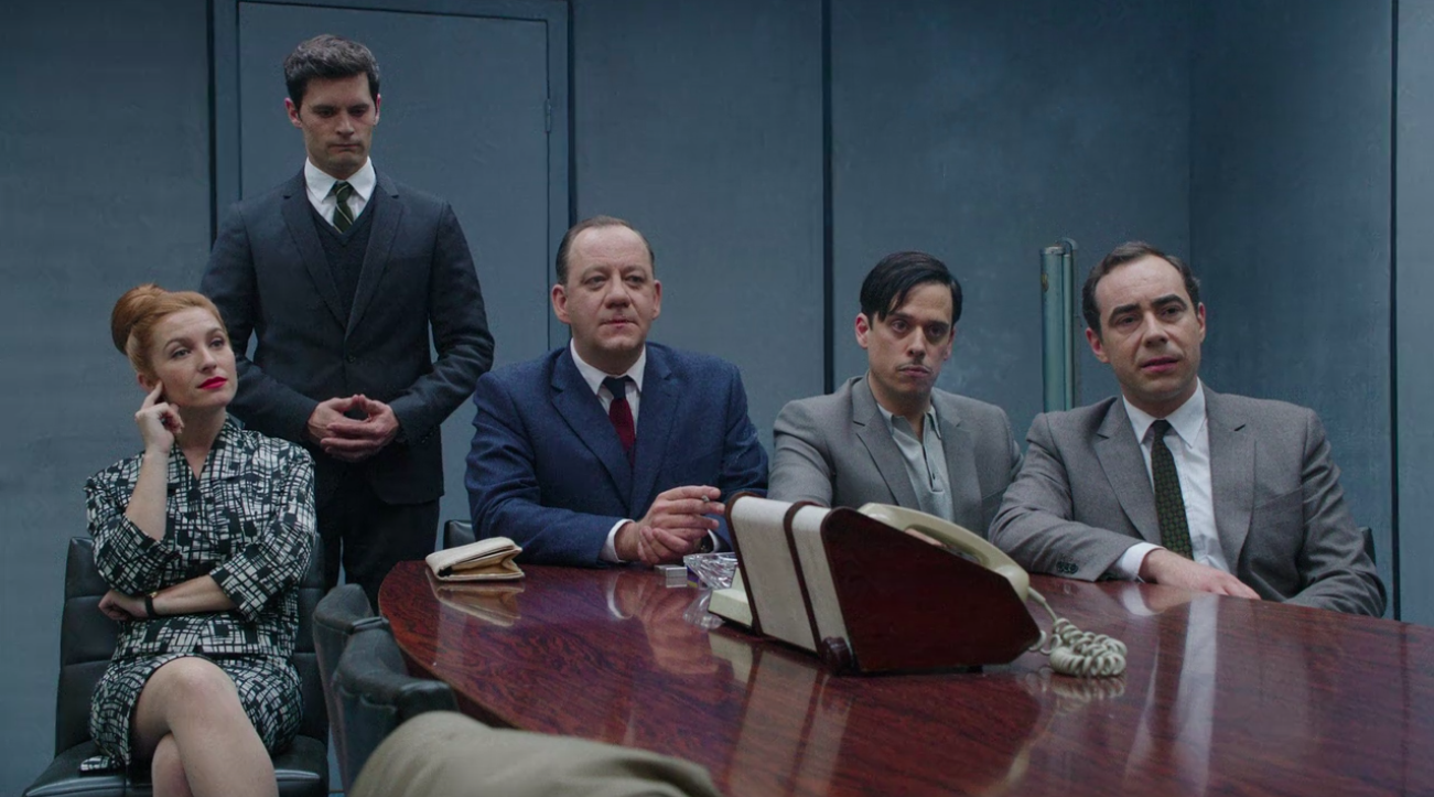 five spies sat around a table